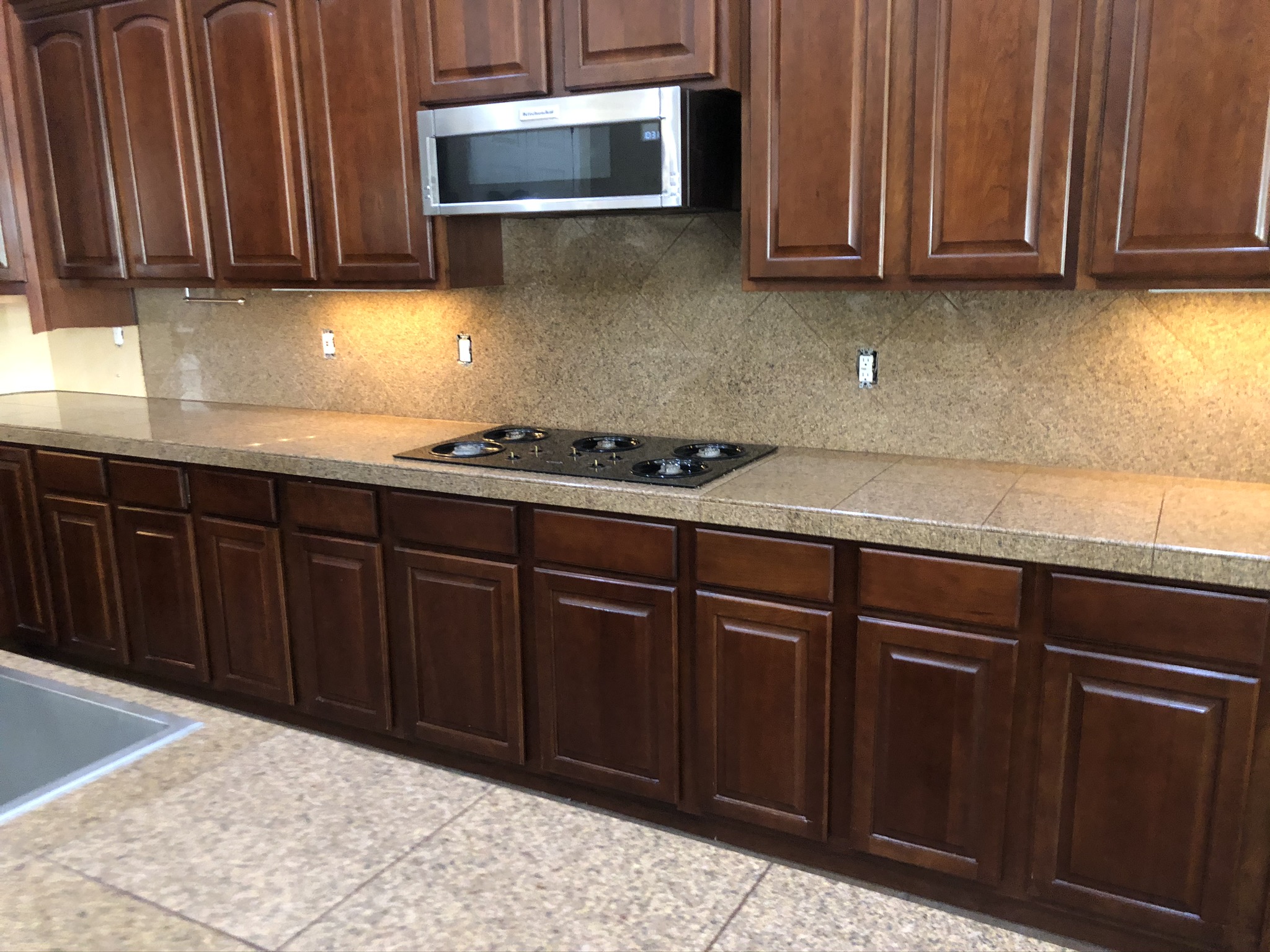 Kitchen with cherry wood cabinetry and granite countertop