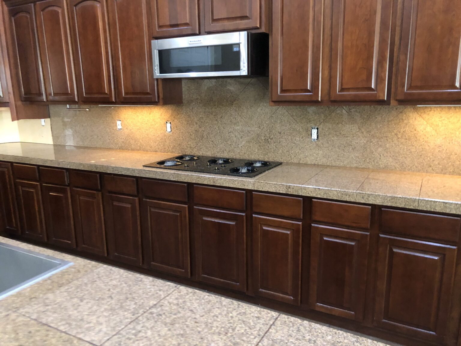 Kitchen with dark wood cabinetry and granite countertop