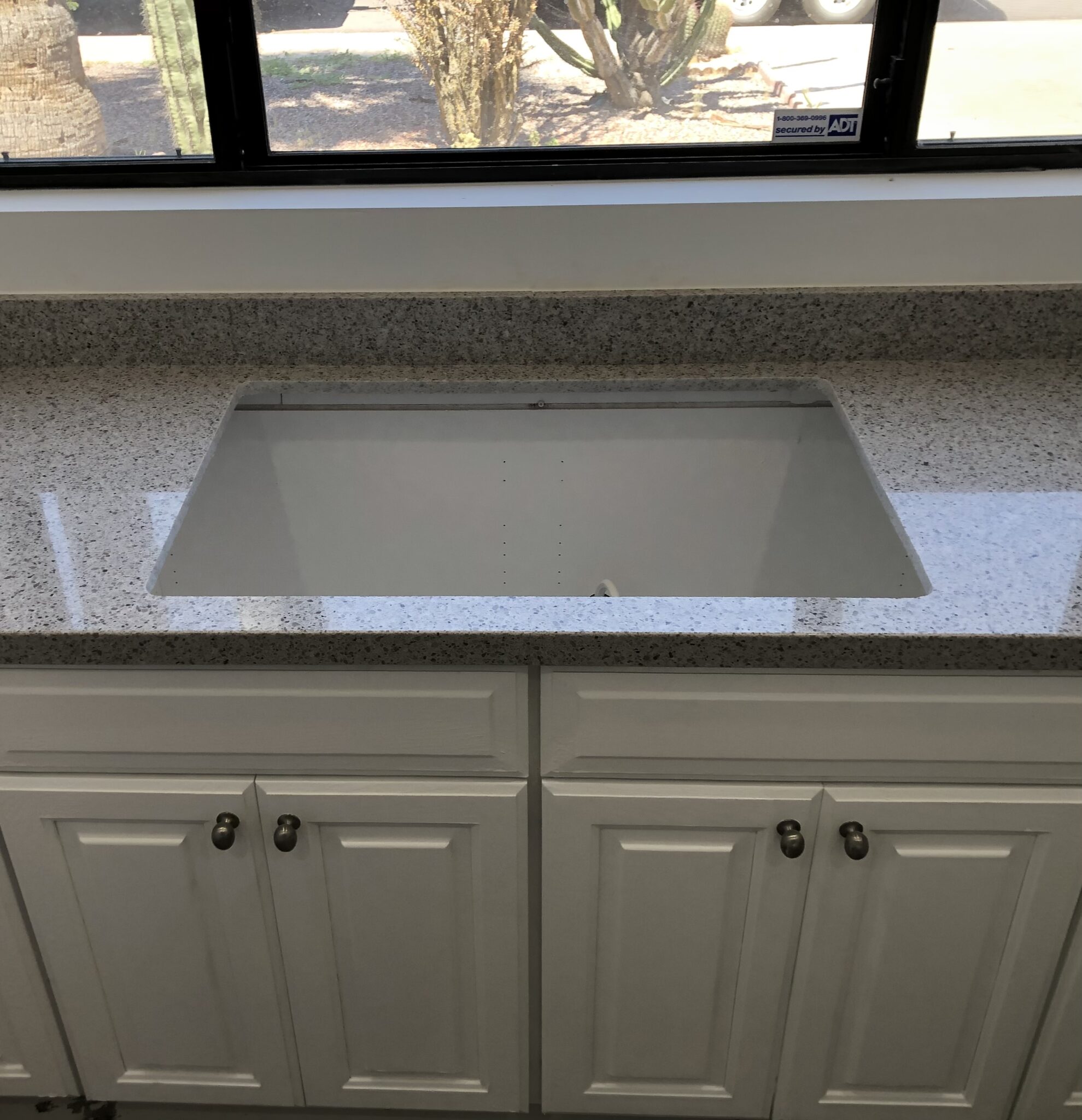 Kitchen sink with gray countertop and natural light