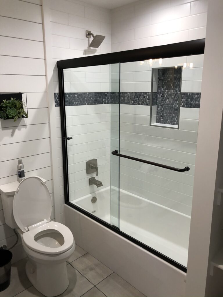 Modern bathroom with glass shower and black framing