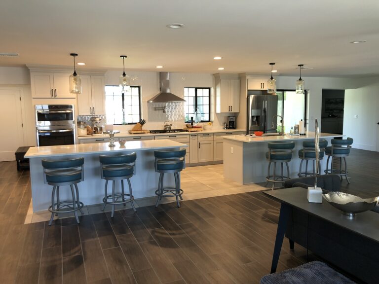 Kitchen with light blue islands and cream cabinetry